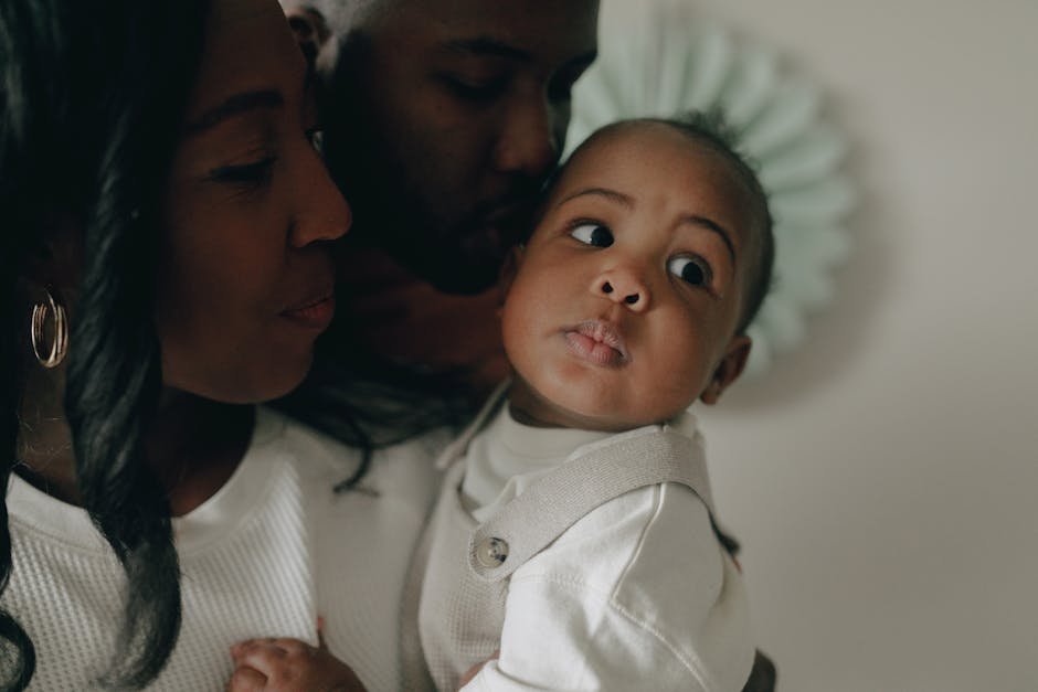 Close-up of a joyful African American family sharing a tender moment with their baby.